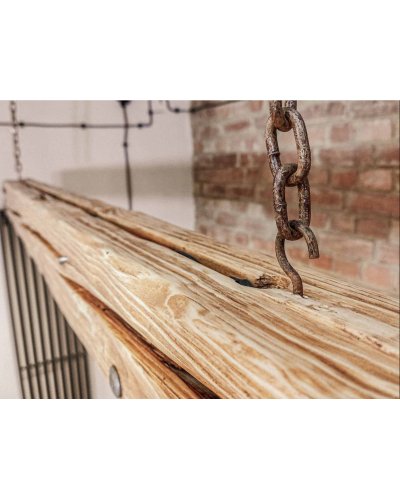 Long wooden lamp with beams on chains in a rustic style.
