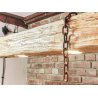Long wooden lamp with beams on chains in a rustic style.